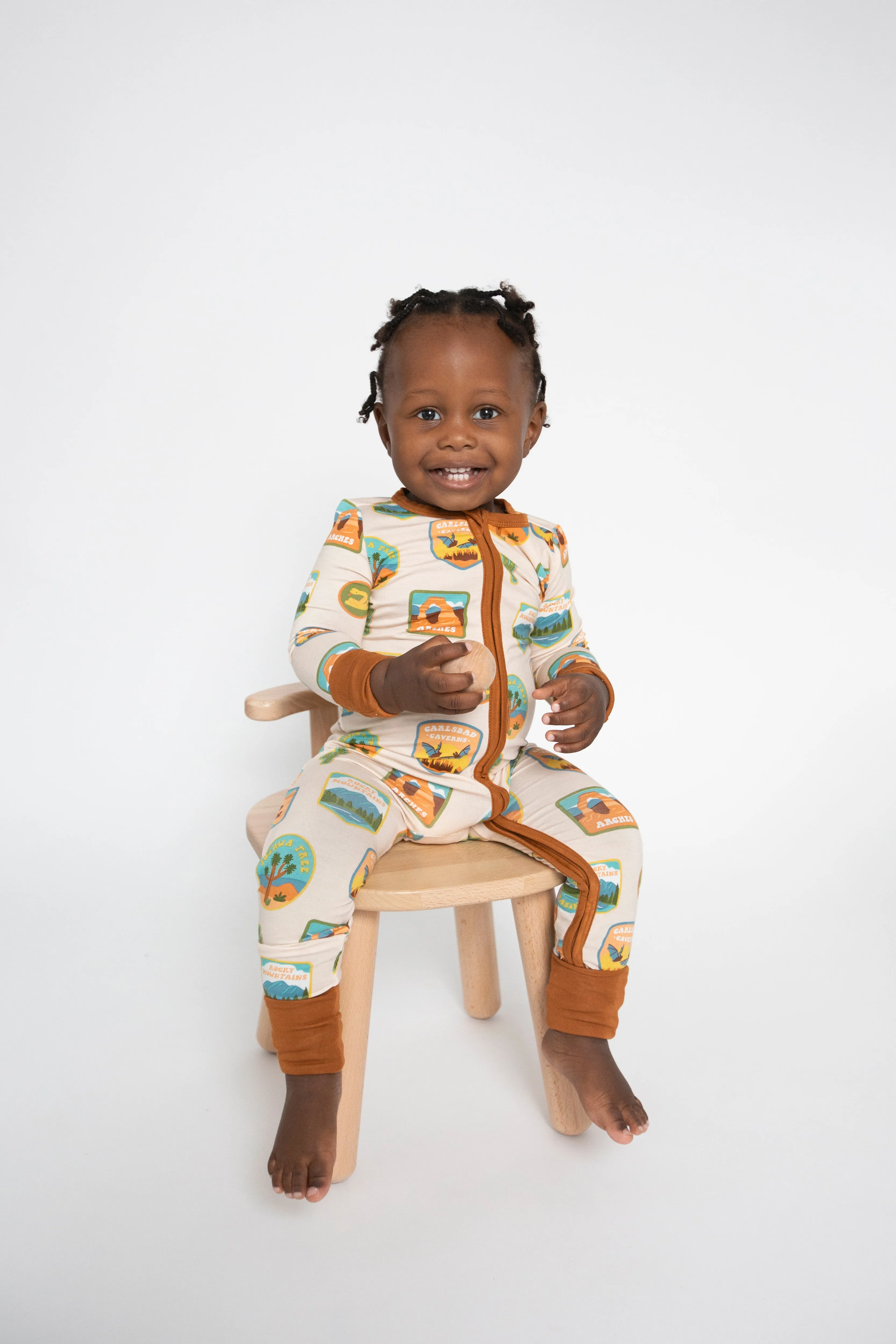 Angel Dear Two Way Zipper Romper in Cream National Parks Patches Southwest
